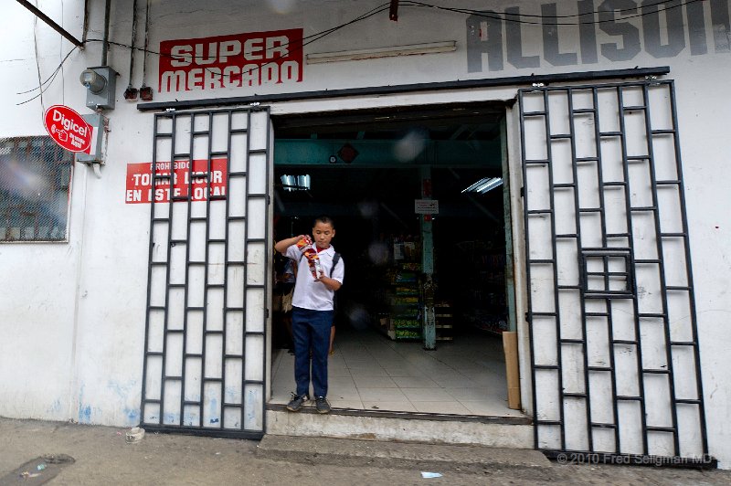 20101202_130020 D3S.jpg - Youngster having a snack doorway of market, Casco Viejo, Panama